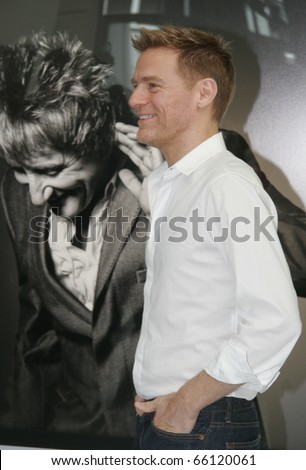 BERLIN - MAY 29: Bryan Adams poses for photographers next to celebrity portraits of his his exhibition \'Hear the World\' on May 29, 2008 in Berlin, Germany.