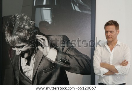 BERLIN - MAY 29: Bryan Adams poses for photographers next to celebrity portraits of his his exhibition \'Hear the World\' on May 29, 2008 in Berlin, Germany.