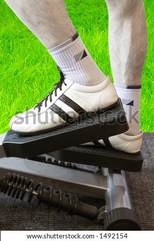 Open Air Fitness (Man\'s Legs On A Fitness Machinery Against Green Grass Background)