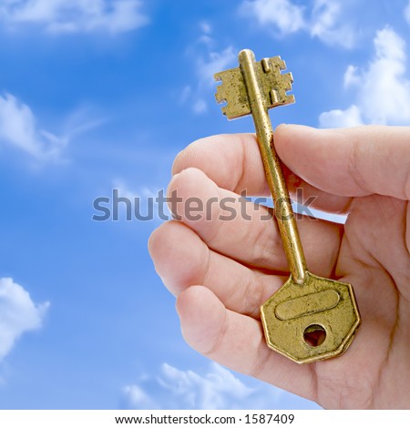 The Key To Success (Golden Key In A Hand Against Blue Sky)