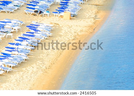 Empty Beach With Lounge Chairs