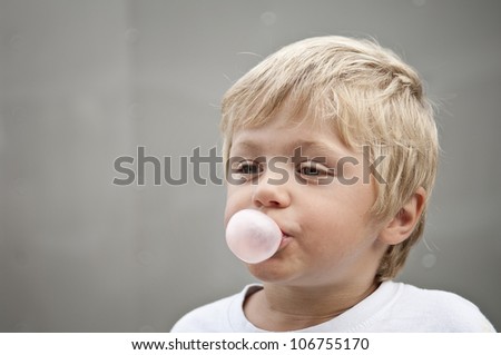 Child blowing a bubble gum