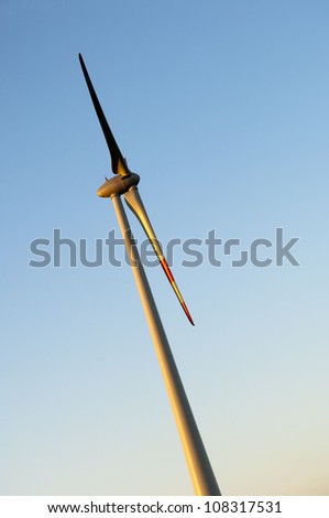 Profil of a Electric wind turbines on sunset background