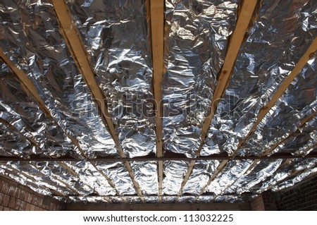 Fiberglass insulation installed in the sloping ceiling of a house.
