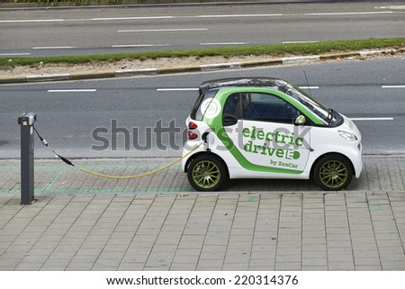 BRUSSELS, BELGIUM - SEPTEMBER 28, 2014: Zen Car Europe\'s first electric car to rent on Bld Botanique in front of the Financial tower on September 28, 2014 in Brussels, Belgium