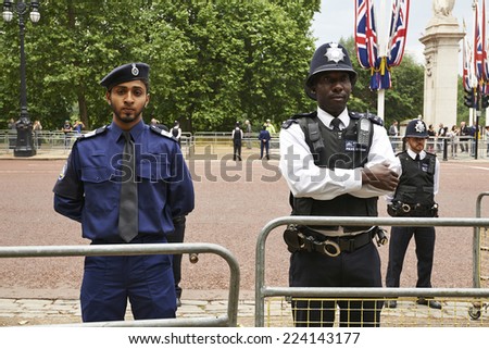 LONDON, ENGLAND - June 07, 2014: Heavily armed police officers on Guard near Buckingham Palace, London for Trooping the Colour in London, England the 07 june 2014