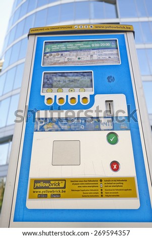 BRUSSELS, BELGIUM - APRIL 15, 2015:  Brussels powered solar parking meter. Parking solutions have been growing in importance to deal with increasing congestion of parking spaces.