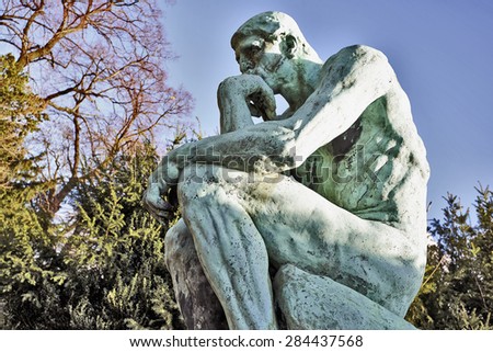 BRUSSELS, BELGIUM - FEBRUARY 16, 2014: The Thinker, bronze cast by Alexis Rudier, Laeken Cemetery, Brussels, Belgium. Rodin sculpted The Thinker in 1880. Replicas now adorn parks, museums, gardens.