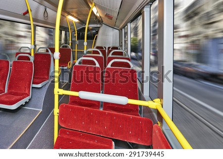 Public Transportation, City Bus Interior with red seats and streets background