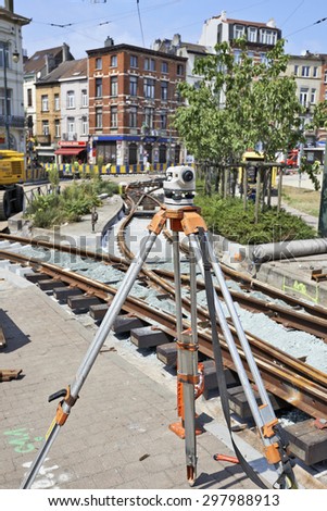 BRUSSELS, BELGIUM -16 JULY 2015: Land Surveying on construction site and some workers repair and replace rail trams in Brussels at Verboekhoven square in Schaerbeek.