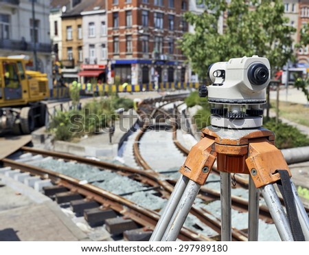 Land Surveying on construction site and some workers repair and replace rail trams