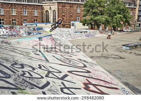 BRUSSELS, BELGIUM -18 JULY 2015: BMX Biker in action at the skate park in central Brussels.The Ursulines square is a public open square in skateboarding, BMX, inline skating, etc.