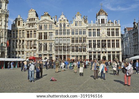 BRUSSELS,BELGIUM - SEPTEMBER 21, 2015: Many tourists enjoy the beauty of the Grand Place in front of newly restored facades