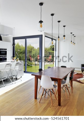 Empty table and chairs in luxury living room with view on garden