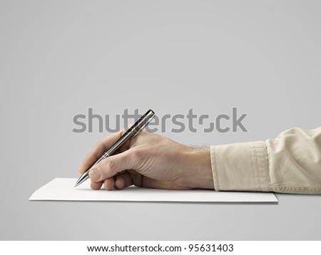 Pen in hand Isolated on grey background (clipping path)