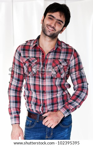 portrait of a happy man wearing checkered shirt