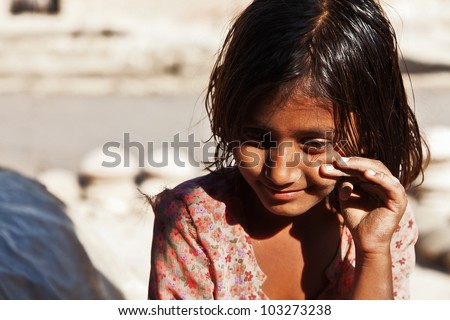 poverty, portrait of a poor little Indian girl lost in deep thoughts