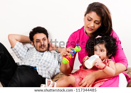 young Indian couple relaxing and enjoying with their daughter