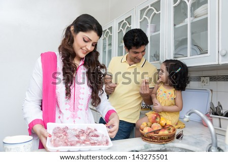 Family Of Three Eating Fruits In The Kitchen, Indian Family In The Kitchen,