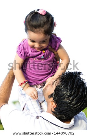 father tossing up the daughter in air, happy indian man tossing his daughter in the air