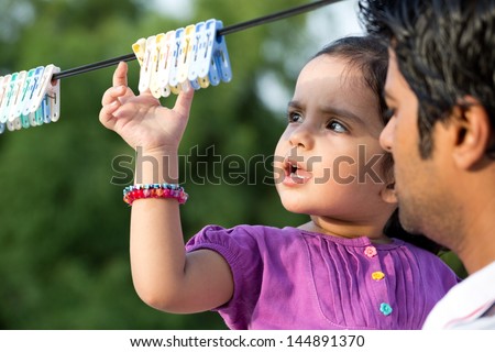 happy father and dauther in the outdoors, Indian man with his two year old daughter