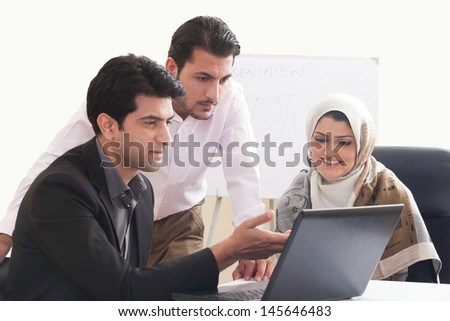 Arab business woman in a meeting with colleagues, three business people in the meeting, ethnic business people, business team.