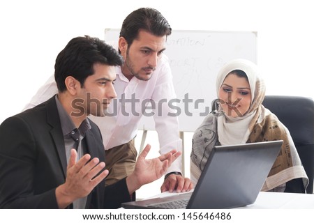 Arab business woman in a meeting with colleagues, three business people in the meeting, ethnic business people, business team.