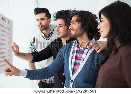 group of multi racial students checking the results