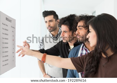 group of multi racial students checking the results