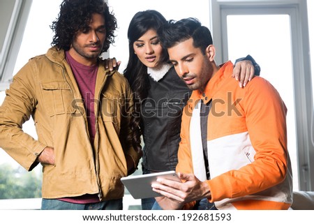 group of  university friends using Pc tablet and hanging out together