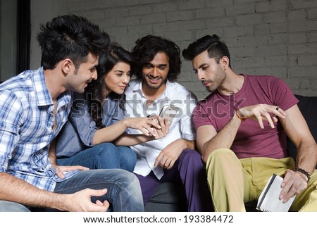 group of friends reading a message on smart phone.