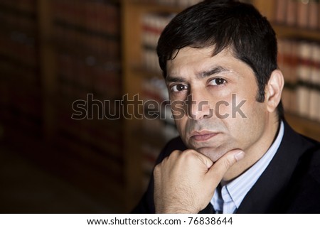 corporate/business lawyer or consultant thinking in the library