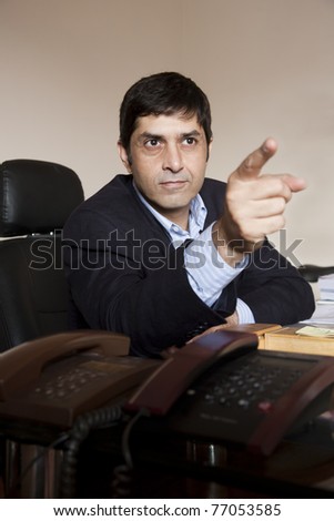 portrait of an angry businessman pointing his finger