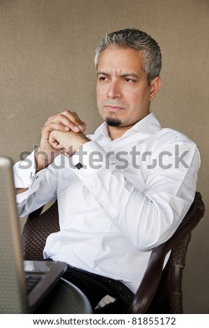 portrait of a handsome businessman with grey hair working on the laptop, Indian muslim businessman working.