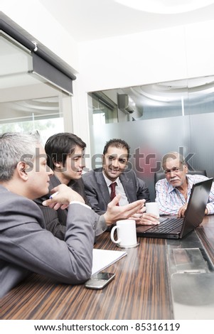 A diversed group of young business executives having a meeting with a senior businessman