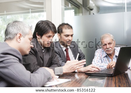 A diversed group of young business executives having a meeting with a senior businessman