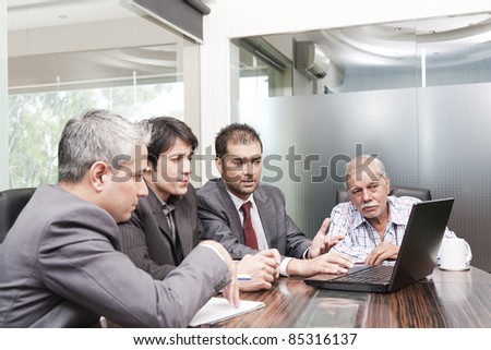 A diverse group of young business executives having a meeting with a senior businessman