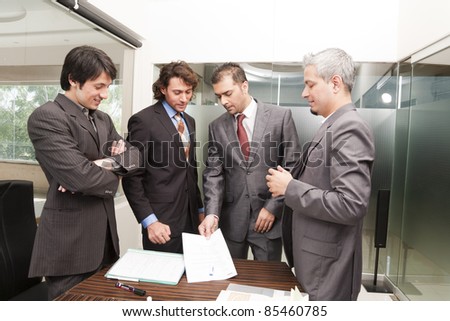 Group of happy businessmen having a casual discussion after the official meeting.