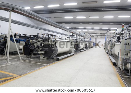 textile looms in a spinning and weaving factory, production hall in a yarn manufacturing factory