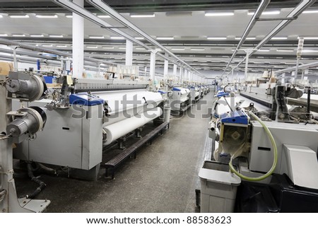 textile looms in a spinning and weaving factory, production hall in a yarn manufacturing factory