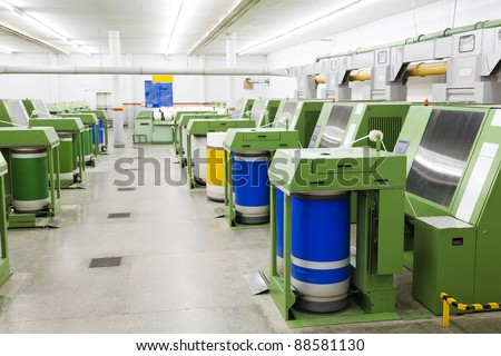 production hall of a spinning a weaving machines in a textile mill, textile factory, yarn manufacturing