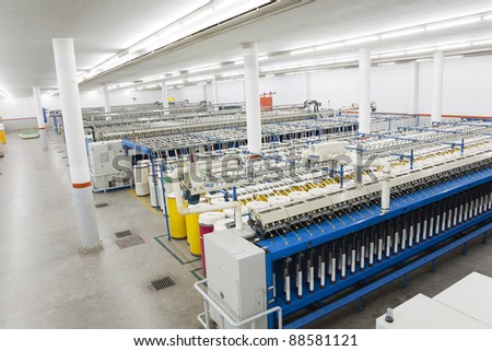 production hall of a spinning a weaving machines in a textile mill, textile factory, yarn manufacturing