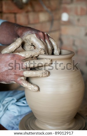 potter making a terracotta clay vase