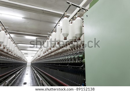 yarn spools on spinning machine in a textile factory