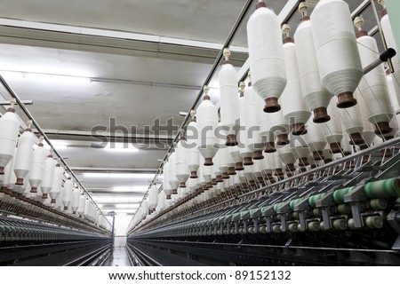 yarn spools on spinning machine in a textile factory
