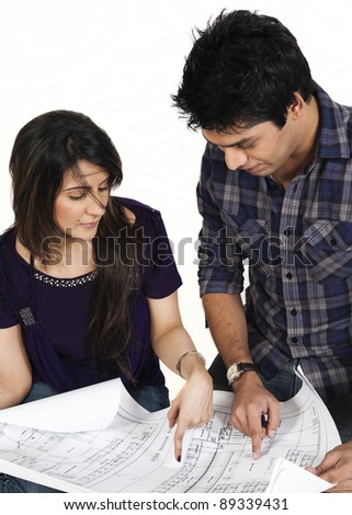 biracial couple, couple discussing the plan of a new house