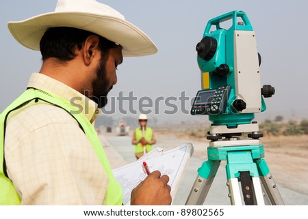 civil engineer working at a construction site, surveyor doing the survey at construction site