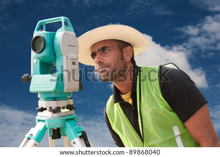 civil engineer doing land survey at a construction site, close up of surveyor working on theodolite