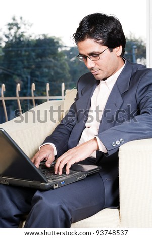 thoughtful Indian businessman working on laptop, businessman lost in deep thoughts