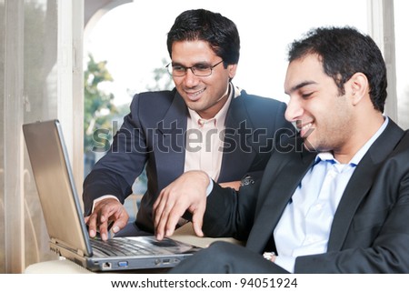 two Indian businessmen in meeting, two businessmen working on the laptop
